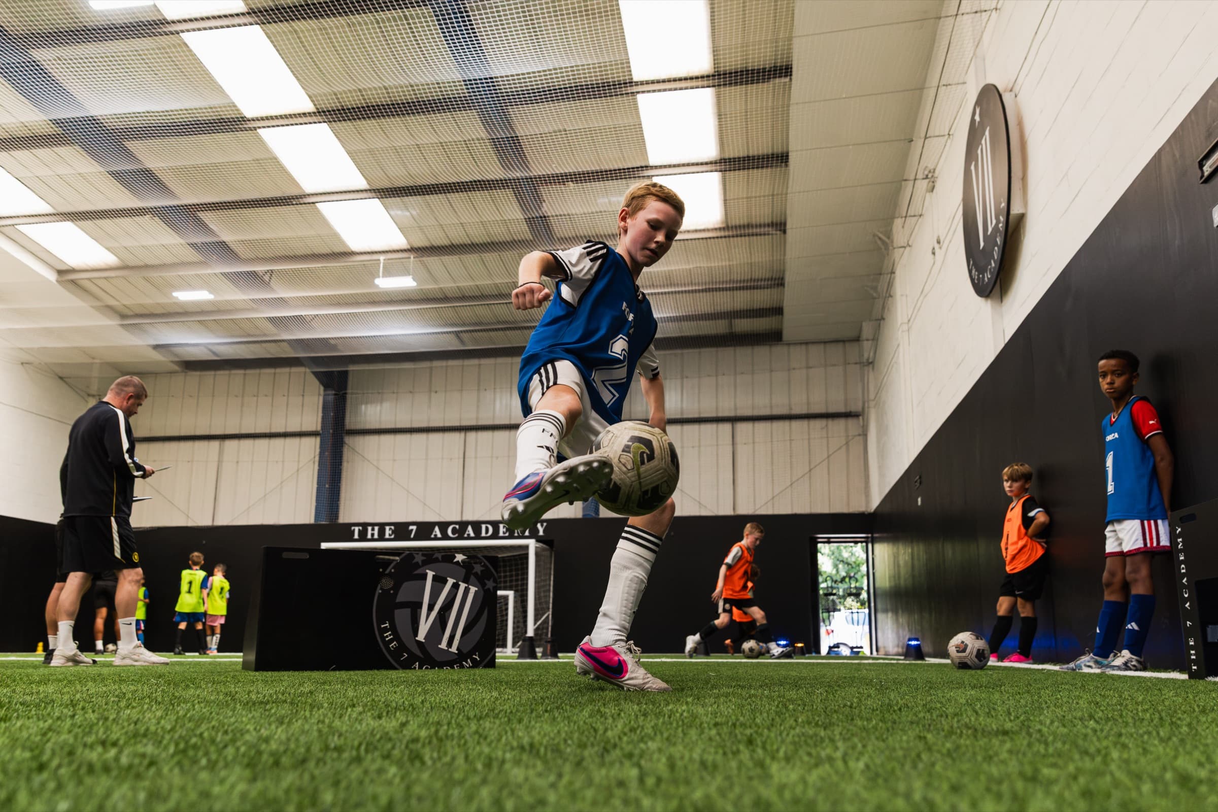 A player striking the ball at a 7 Academy performance camp