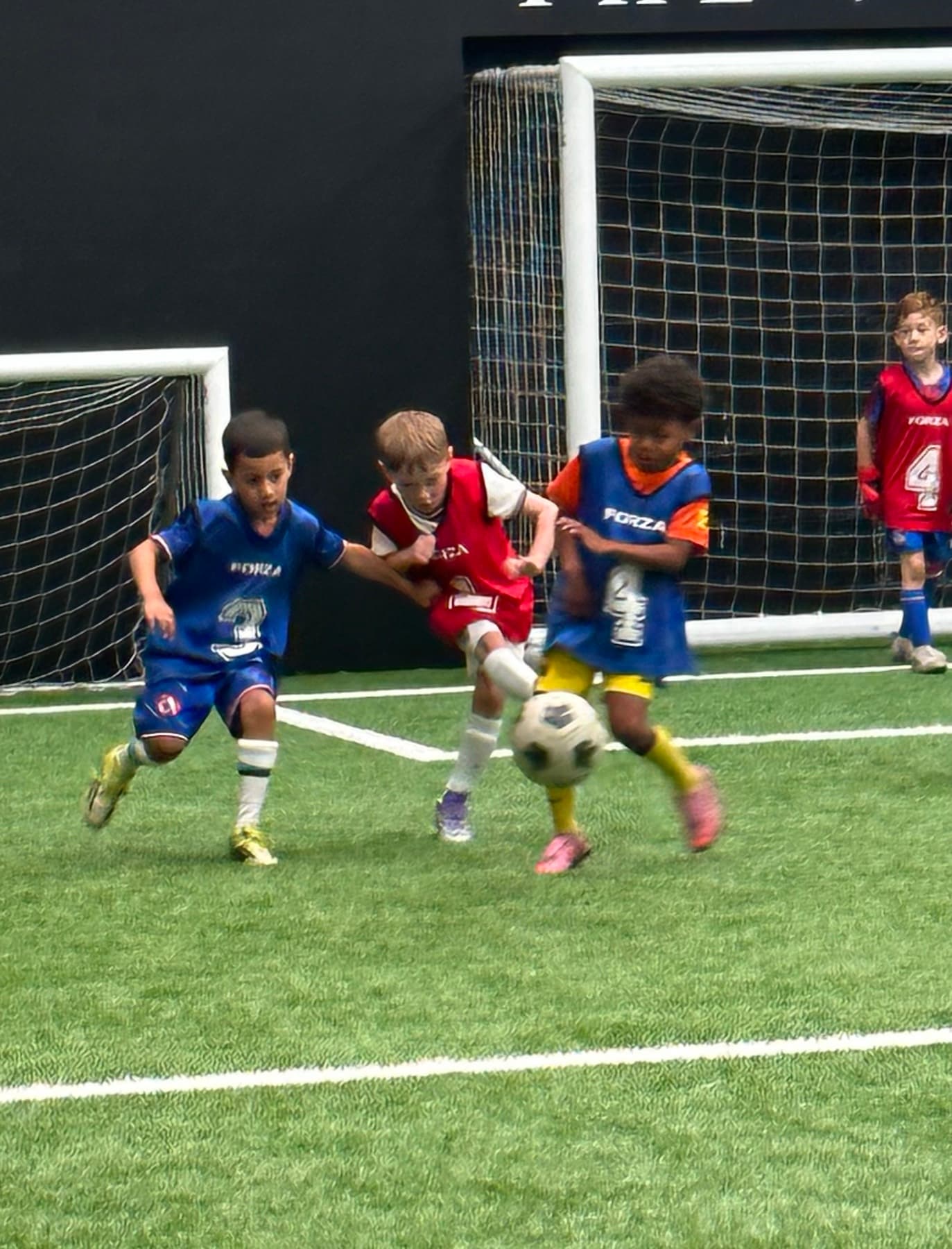 Young players competing for the ball at The 7 Academy