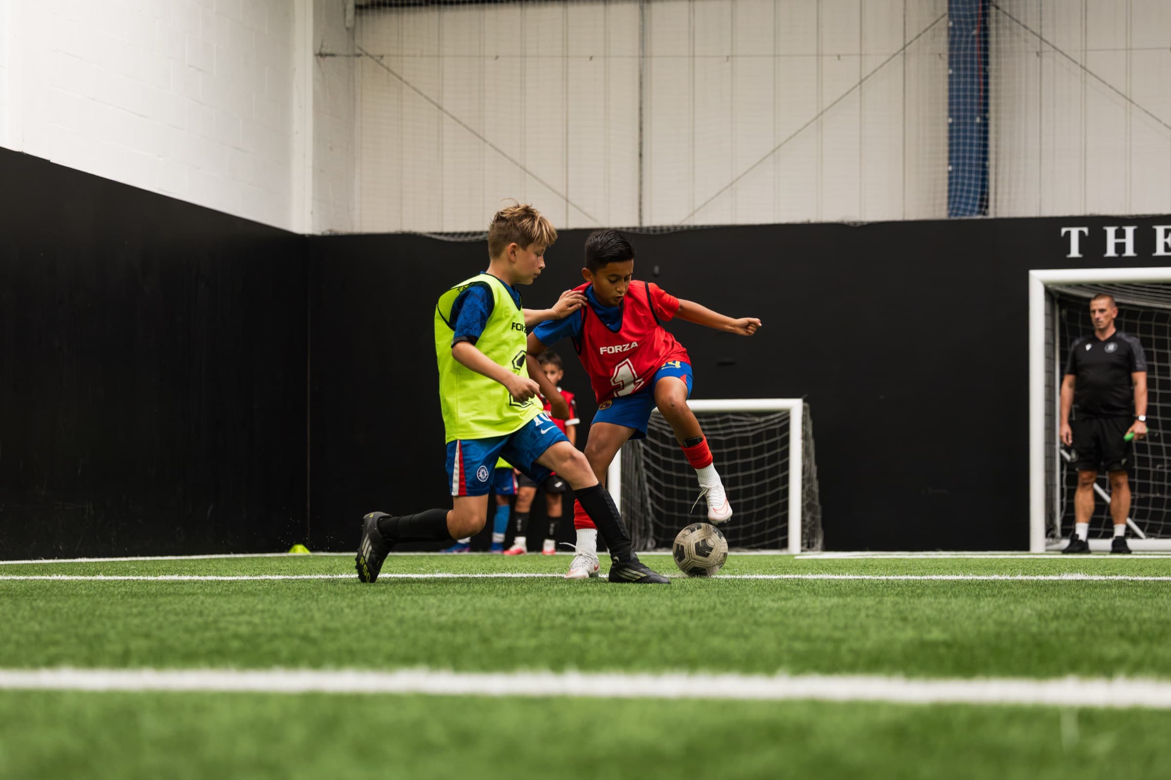 Players competing for the ball at The 7 Academy in Esher